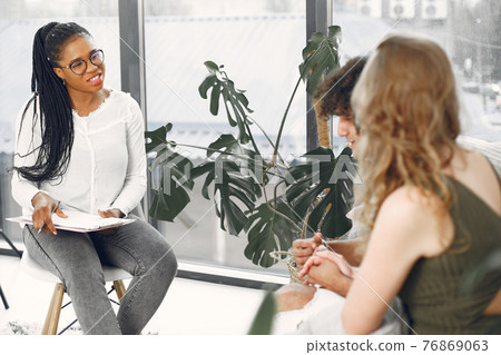 Couple having conversation with psychologist on therapy 76869063