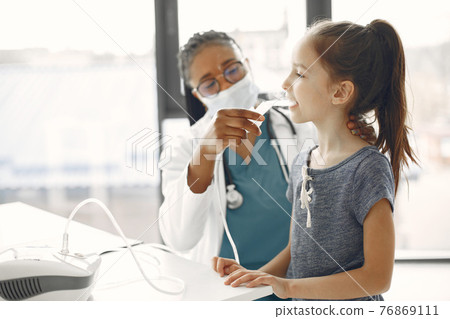 Doctor makes a procedure for a little girl Doctor makes a procedure for a little girl 76869111