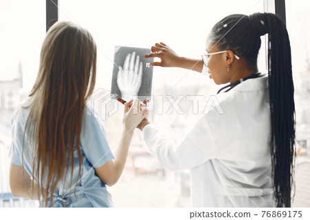 Two female doctors looking at an x-ray 76869175