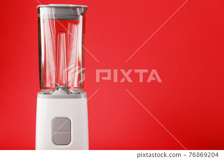 Blender with cup on red background with free space. 76869204