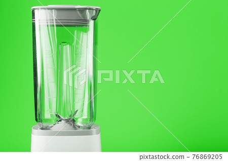Electric blender with an empty jug on a green background. Electric blender with an empty jug on a green background. 76869205