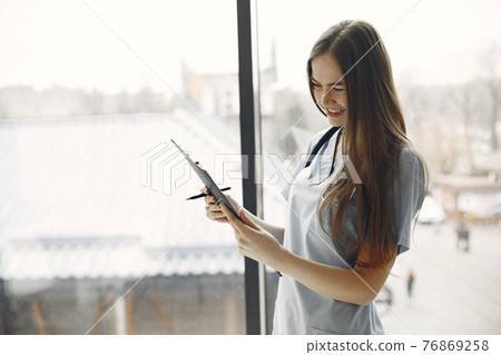Girl in form of a doctor with long hair 76869258