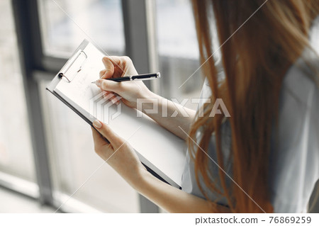 Girl in form of a doctor with long hair Girl in form of a doctor with long hair 76869259