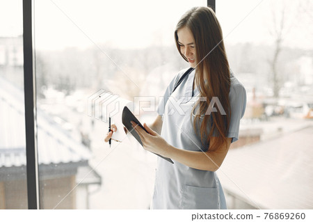 Girl in form of a doctor with long hair 76869260