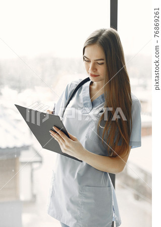 Girl in form of a doctor with long hair Girl in form of a doctor with long hair 76869261