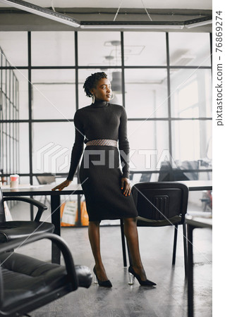 Portrait of a confident black businesswoman working at office Portrait of a confident black businesswoman working at office 76869274