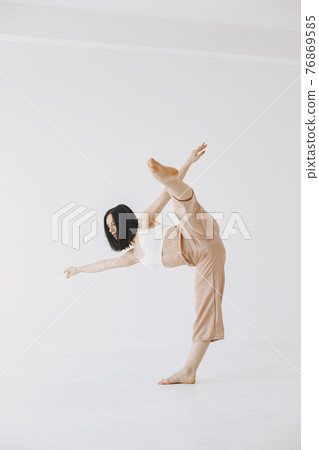Beautiful young woman dancing in studio 76869585