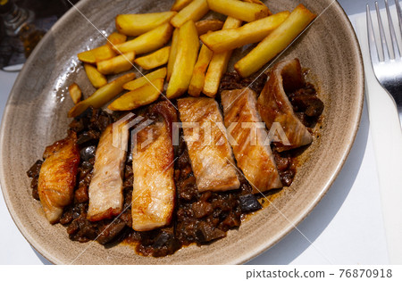 Iberian pork in sweet wine with stewed vegetables. Spanish dish Iberian pork in sweet wine with stewed vegetables. Spanish dish 76870918