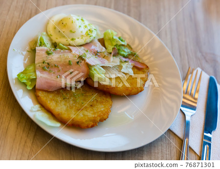 Potato pancakes served with bacon and egg Potato pancakes served with bacon and egg 76871301