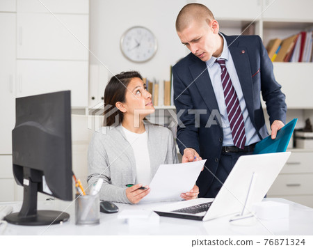 Businessman and business woman working together at office 76871324