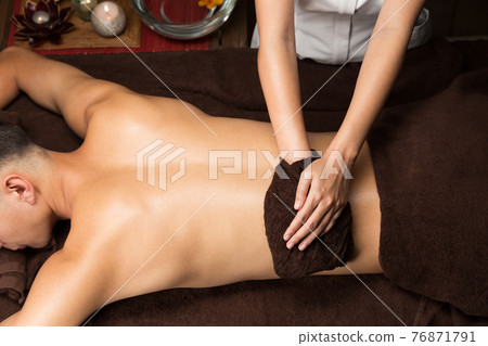 Woman wiping the back of a man 76871791