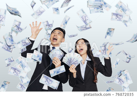 young business man woman dollars under money young business man woman dollars under money 76872035