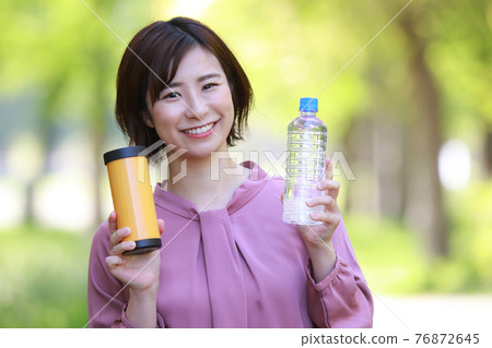 Woman with my bottle and mineral water Woman with my bottle and mineral water 76872645
