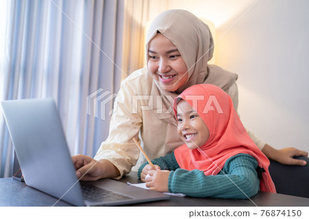 mother help her daughter to learn online using laptop studying from home 76874150