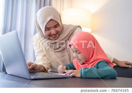 muslim mother help her daughter to study during home schooling muslim mother help her daughter to study during home schooling 76874165