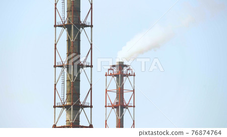 Photo of industrial factory with white smoke from pipes 76874764