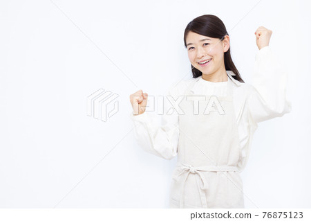 Housewife in her thirties doing a guts pose Housewife in her thirties doing a guts pose 76875123
