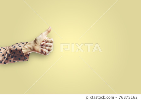 Woman arm making ok gesture with hand isolated on yellow background Woman arm making ok gesture with hand isolated on yellow background 76875162