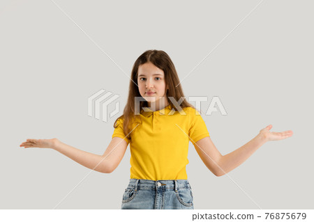 Caucasian girl isolated on white studio background. Copyspace. Childhood, education, emotions concept Caucasian girl isolated on white studio background. Copyspace. Childhood, education, emotions concept 76875679