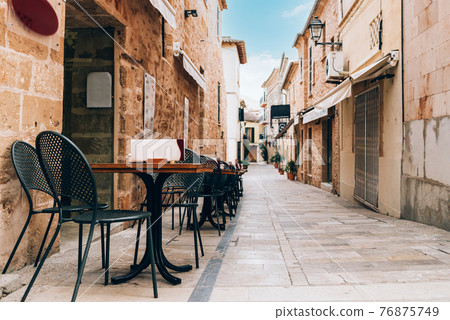 Empty tables of street cafe, Spain Empty tables of street cafe, Spain 76875749
