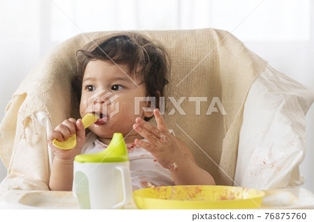 Little cute child celebrating her first birthday with cake at home. Little cute child celebrating her first birthday with cake at home. 76875760