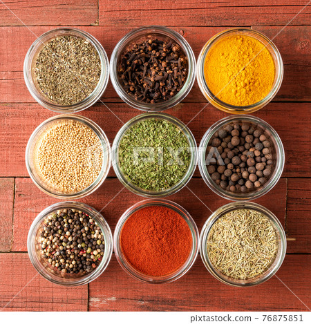 Colourful spices in bowls on wooden table. Big collection of spices. Top view Colourful spices in bowls on wooden table. Big collection of spices. Top view 76875851