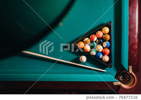 Billiard table with green surface and balls in the billiard club.Pool Game Billiard table with green surface and balls in the billiard club.Pool Game 76877216