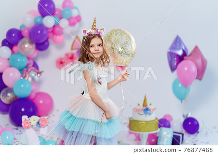 Unicorn Girl holding gold confetti air baloon. Idea for decorati 76877488