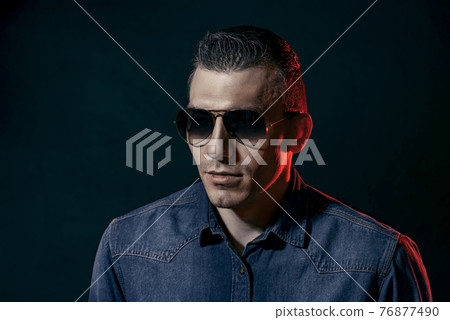 American man. Sexy brutal man in glasses. Stylish man or casual American man. Sexy brutal man in glasses. Stylish man or casual 76877490