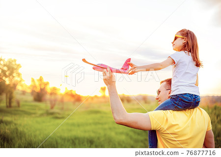 Happy father and daughter playing with plane 76877716