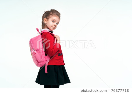 Adorable little girl in red school jacket, black dress, on to th Adorable little girl in red school jacket, black dress, on to th 76877718