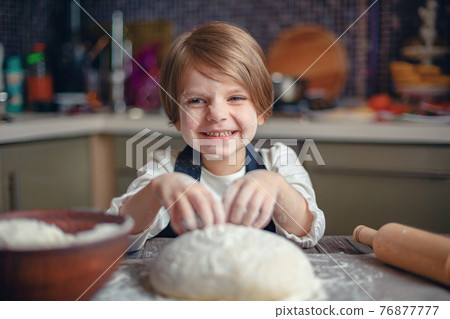 Little child girl with short hair haircut cooking dough Little child girl with short hair haircut cooking dough 76877777