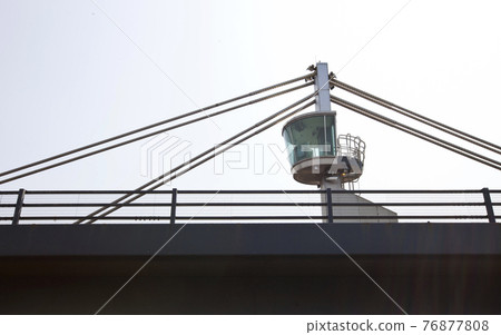 Close-up view of a control tower on top of a bridge 76877808