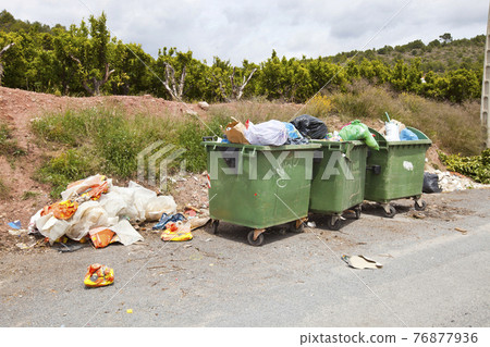 Overflowing bins next to Orange Orchard, Valencia region, Spain Overflowing bins next to Orange Orchard, Valencia region, Spain 76877936