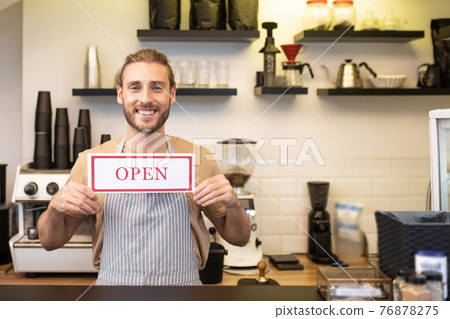 Happy man near bar counter with sign open Happy man near bar counter with sign open 76878275
