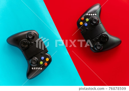 A Black game Joystick isolated on a red and blue background A Black game Joystick isolated on a red and blue background 76878509