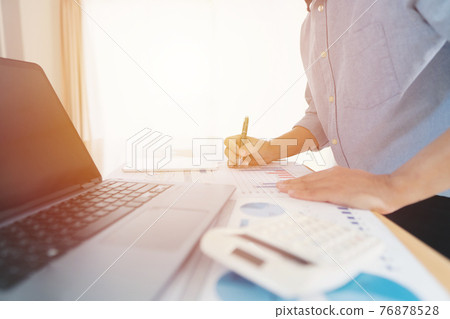 Businessman hand analyzing chart on paper investment charts with laptop. Accounting. Business concept Businessman hand analyzing chart on paper investment charts with laptop. Accounting. Business concept 76878528