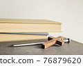 A cross with nail with bible over a light background.  76879620