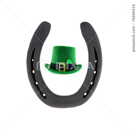 green traditional leprechaun hat and iron horseshoe symbol of good luck on white background green traditional leprechaun hat and iron horseshoe symbol of good luck on white background 76880418