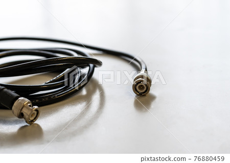 coaxial wire for cable television signal transmission on a light background 76880459