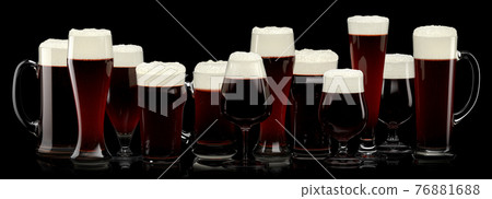 Set of fresh stout beer glasses with bubble froth isolated on black background. Set of fresh stout beer glasses with bubble froth isolated on black background. 76881688