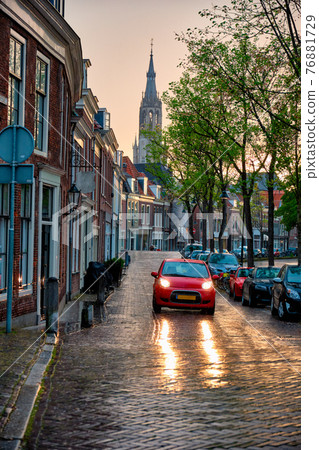 Delft cobblestone street with car in the rain 76881729