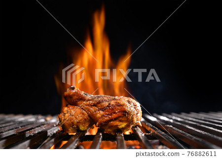 Grilled chicken legs on the flaming grill Grilled chicken legs on the flaming grill 76882611