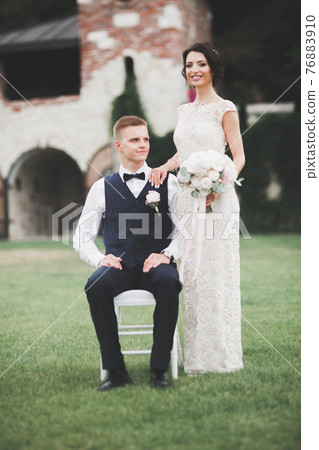 Luxury married wedding couple, bride and groom posing in old city Luxury married wedding couple, bride and groom posing in old city 76883910