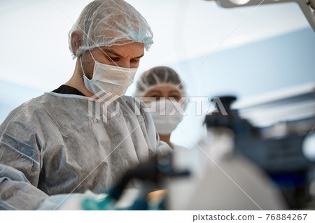 Team surgeon at work in operating room. Team surgeon at work in operating room. 76884267