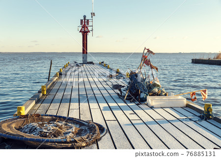 Frozen pier in winter Frozen pier in winter 76885131