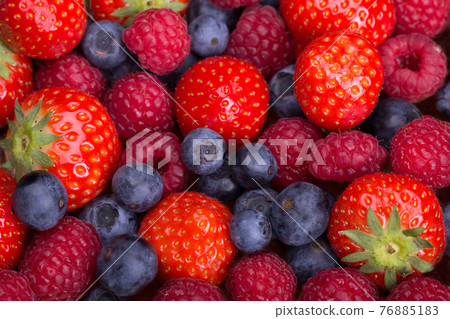 Strawberries, blueberries, raspberries scattered top view Strawberries, blueberries, raspberries scattered top view 76885183