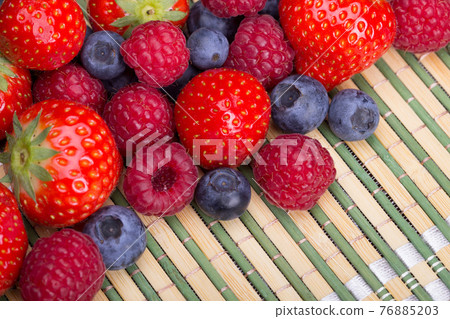 Strawberries, blueberries, raspberries scattered top view Strawberries, blueberries, raspberries scattered top view 76885203