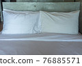 White pillows on a bed Comfortable soft pillows on the bed. 76885571