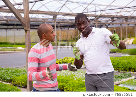 Communication between two gardeners during break between work Communication between two gardeners during break between work 76885591